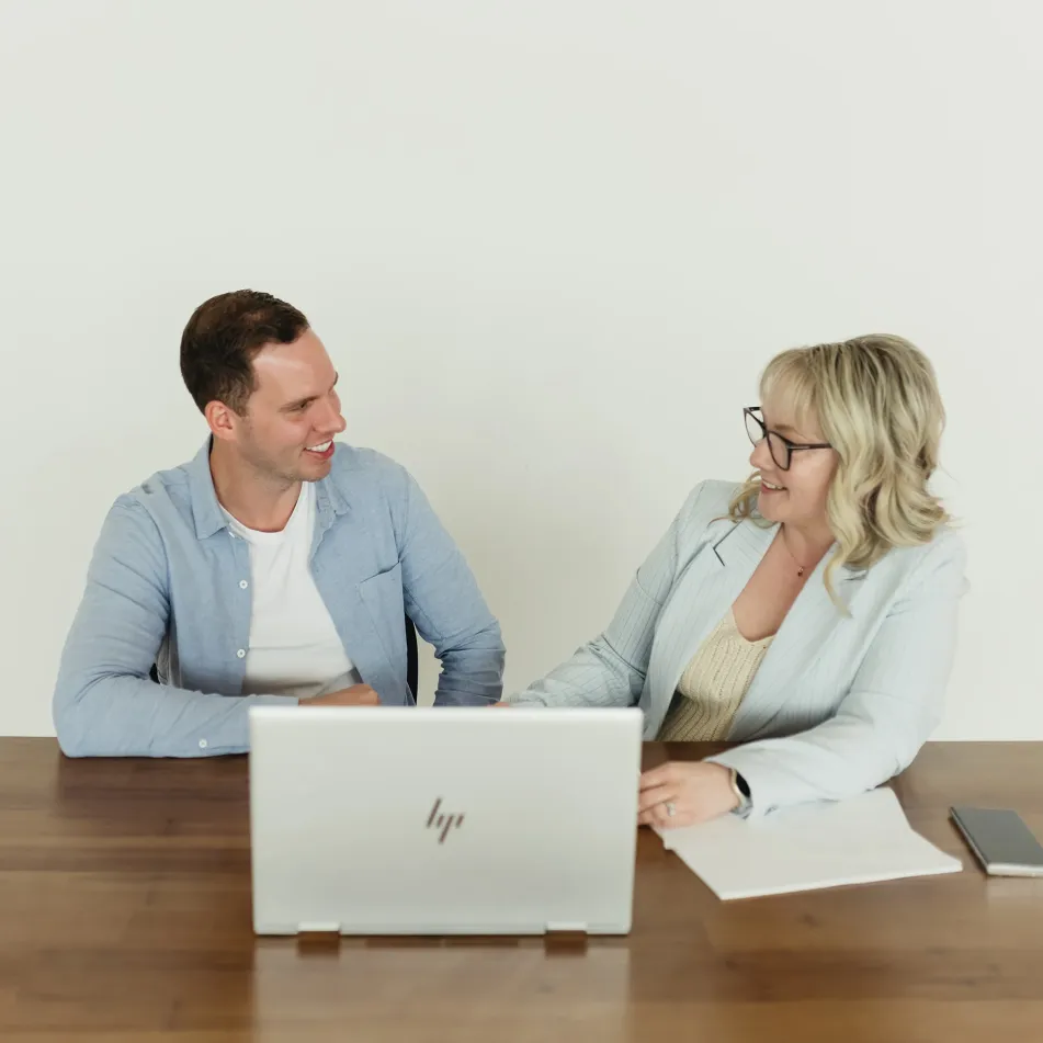 Stephanie from Cue2Convert talking to a client about paid advertising in Edmonton.