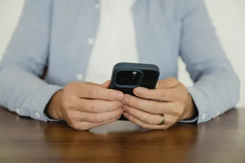A Cue2Convert client checking the results on his phone of his paid advertising in Edmonton.