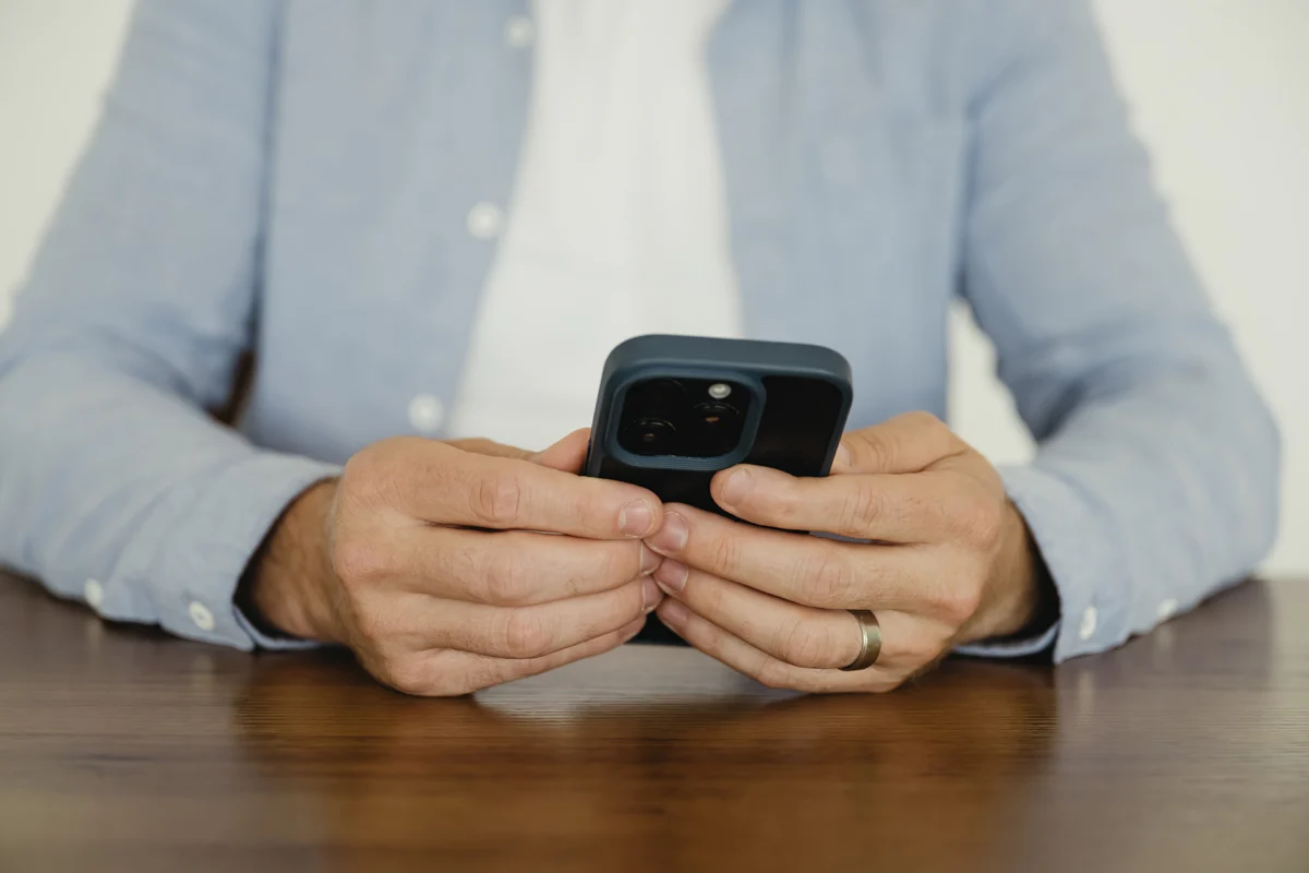 A Cue2Convert client checking the results on his phone of his paid advertising in Edmonton.