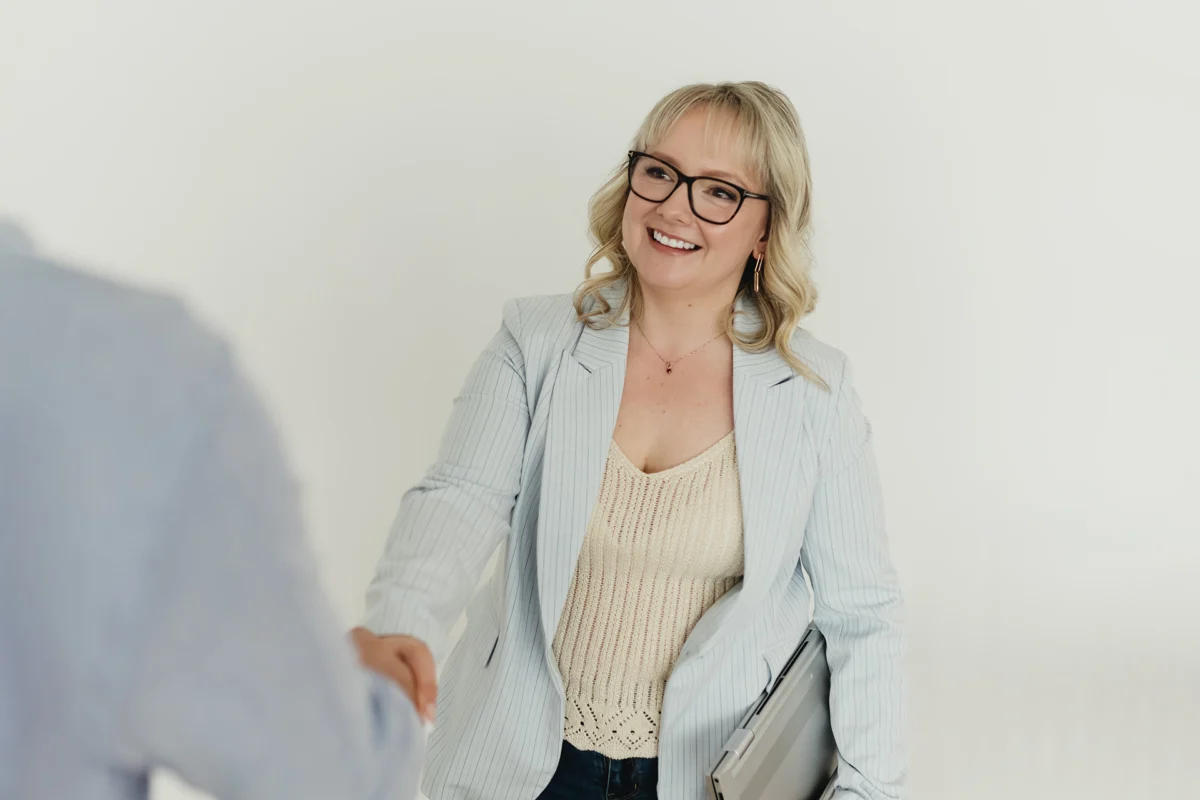 Stephanie, owner of Cue2Convert, shaking hands with client after having a meeting going over their paid advertising in Edmonton.