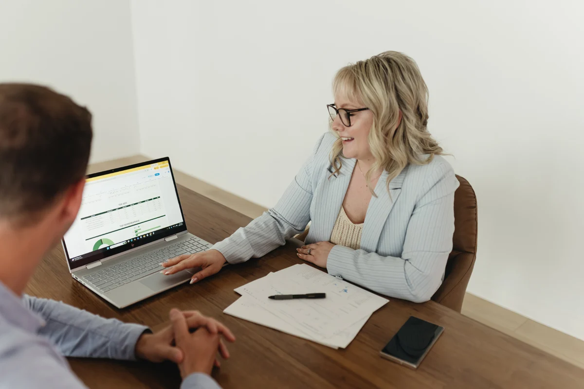 Stephanie showing computer to client showing their paid advertising insights.