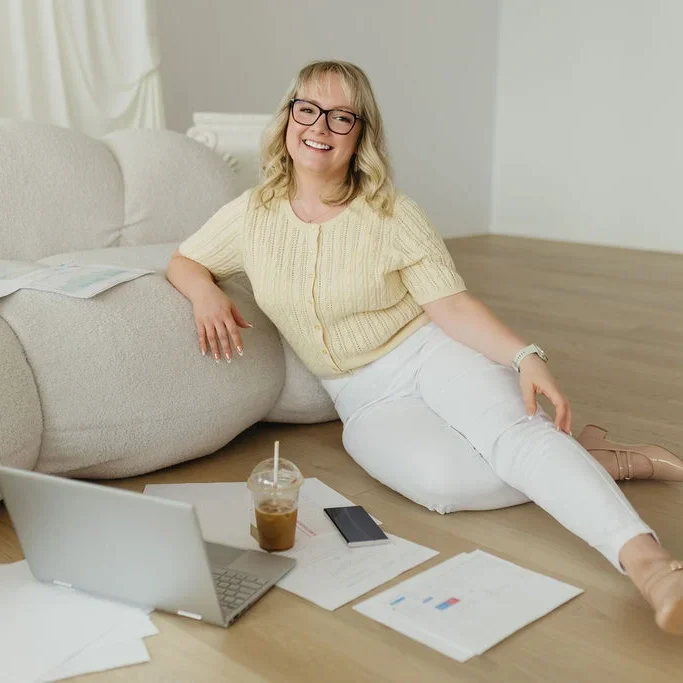 Stephanie, Founder and Growth Strategist, sitting on floor discussing her Paid Advertising Process Edmonton.